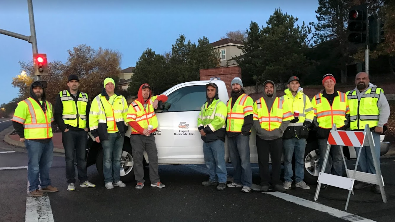 capitol barricade crew standing around work truck with custom lettering