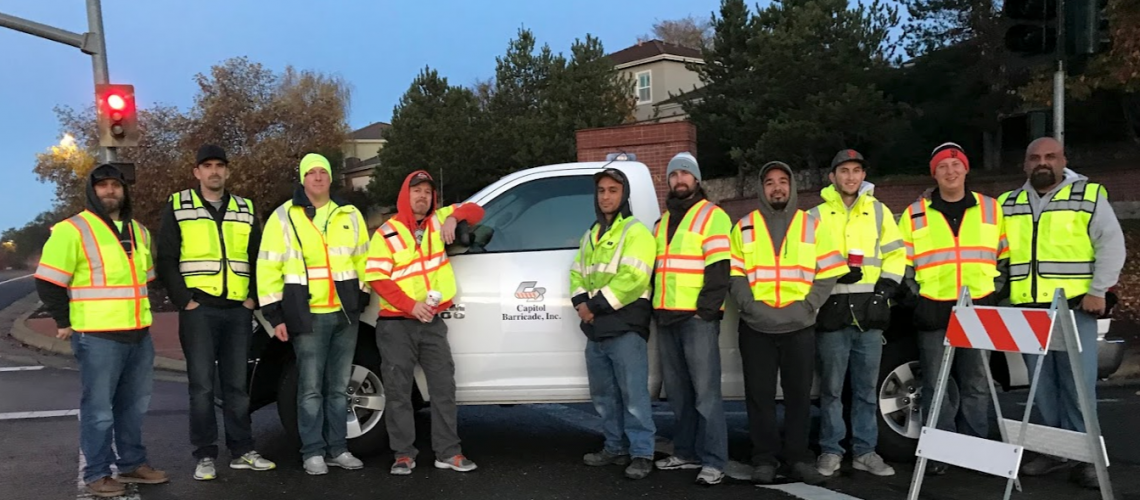 capitol barricade crew standing around work truck with custom lettering