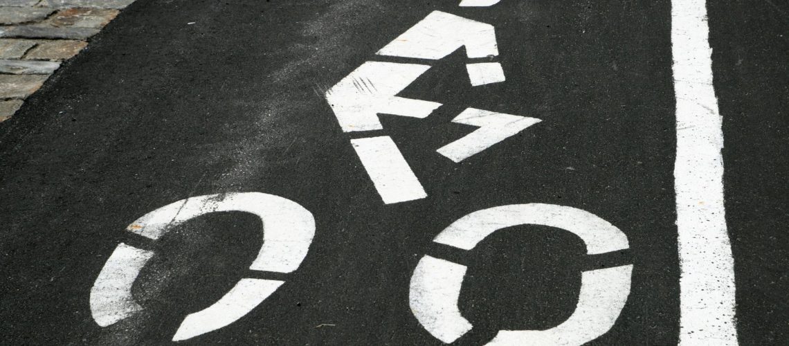 white bicycle painted onto asphalt from stencil