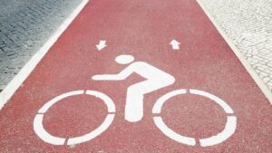 road stencil of person riding bicycle