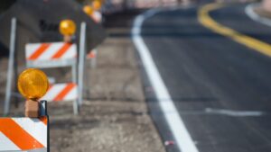 traffic barricades with lights on them in the traffic zone