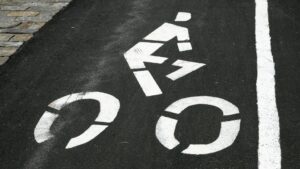 white bicycle painted onto asphalt from stencil