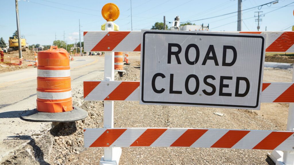 road closed sign over road with construction